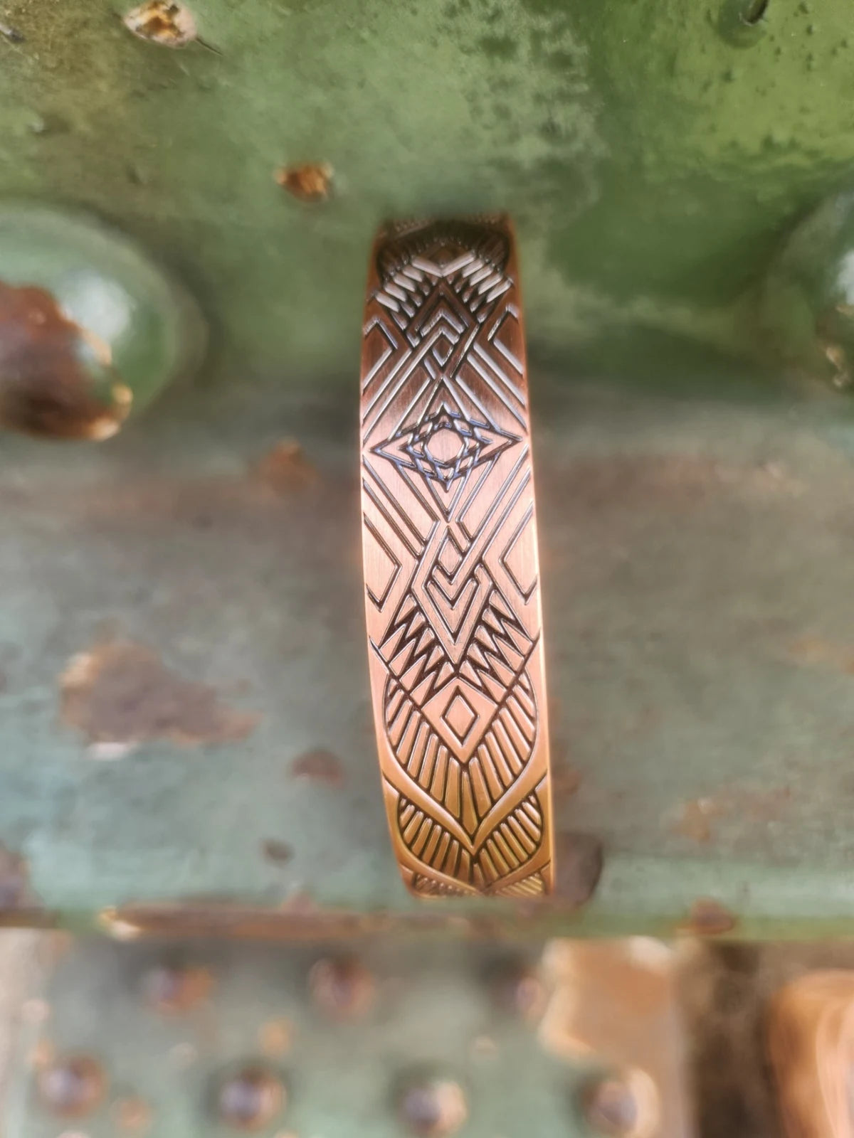 Overhead detail of geometric diamond copper cuff