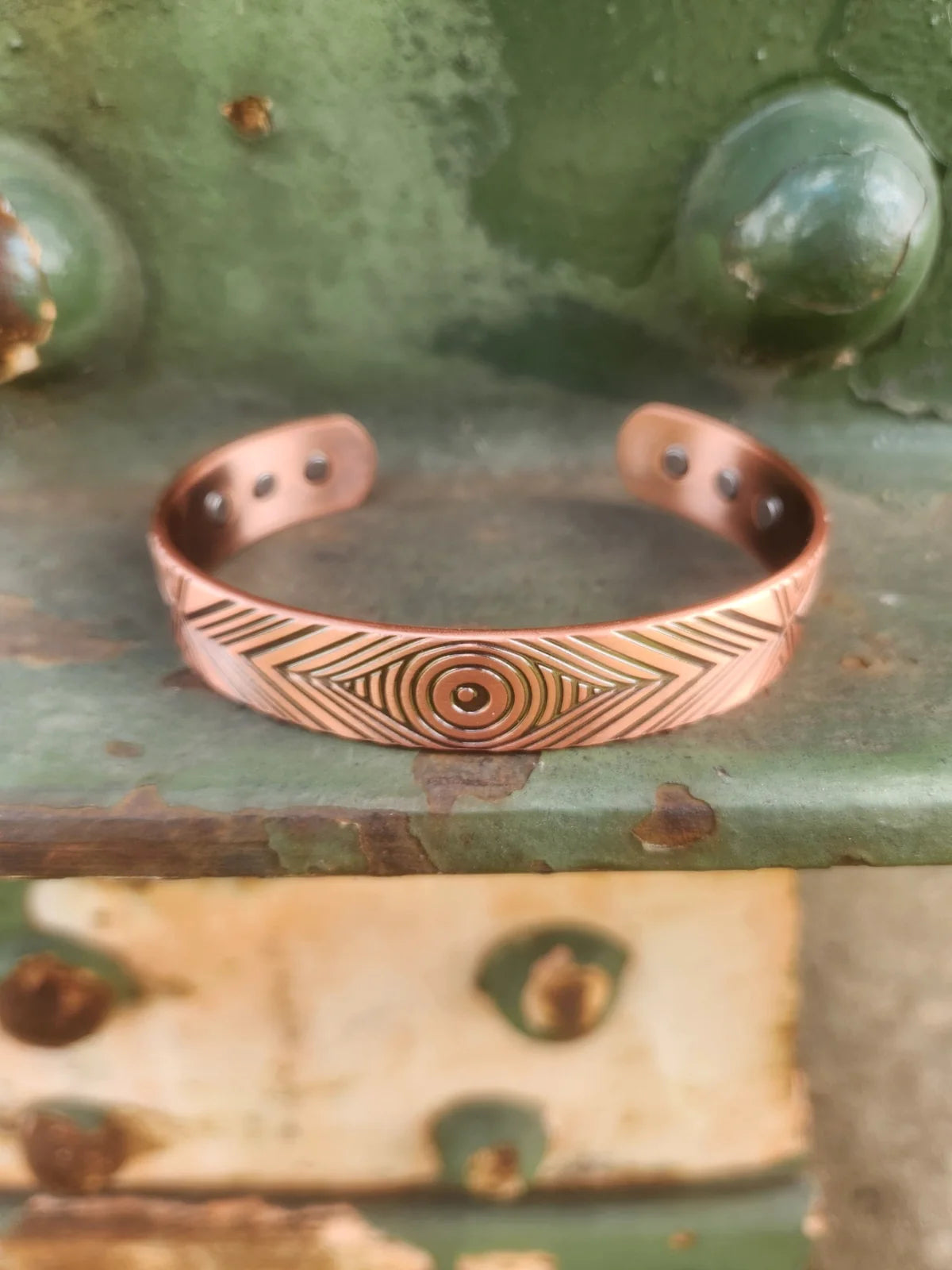 Copper magnetic cuff bracelet front view with concentric circle and chevron pattern