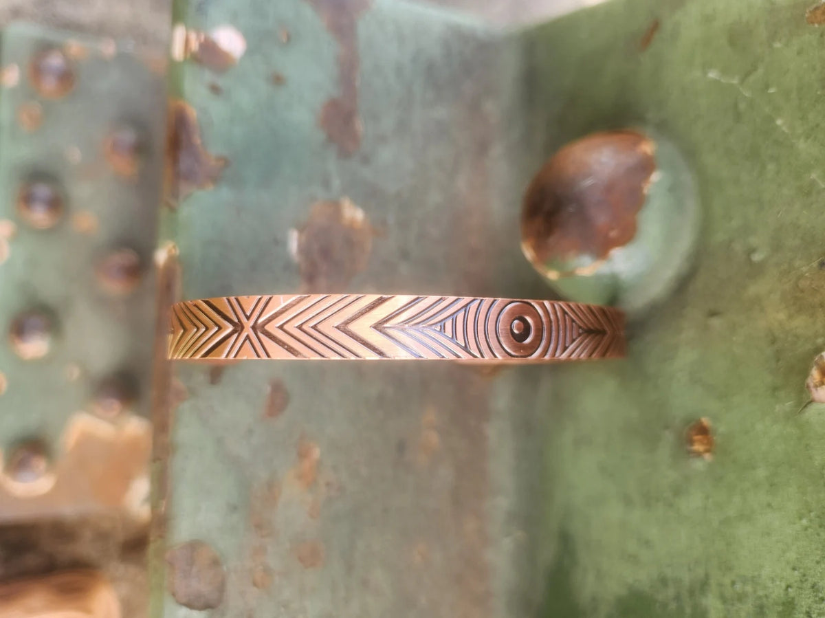 Top view of narrow concentric circle geometric copper bracelet