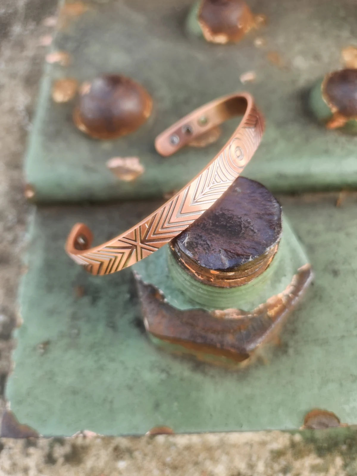 Angled view of narrow magnetic copper cuff