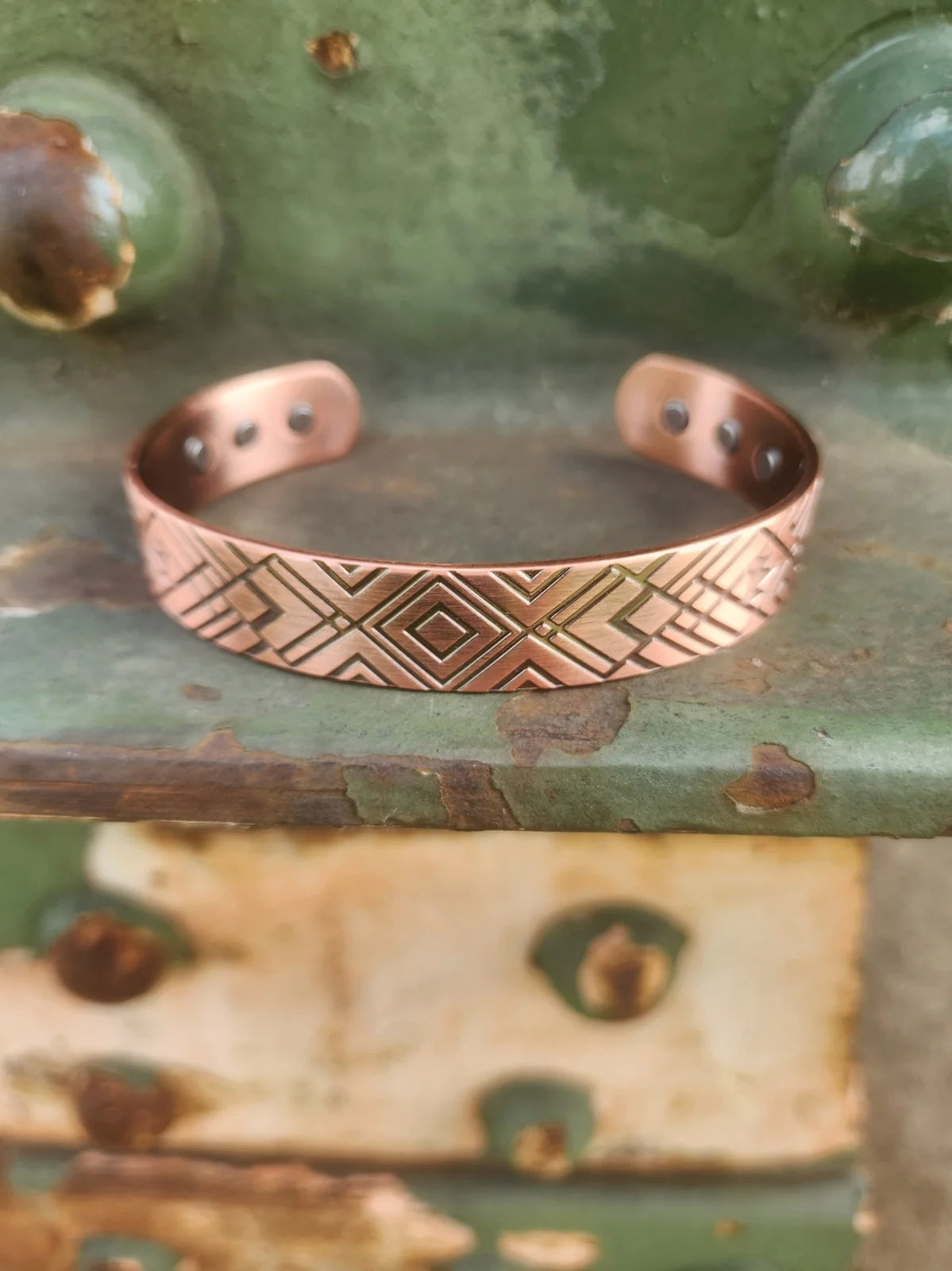 Front view of diamond and cross patterned magnetic copper cuff bracelet