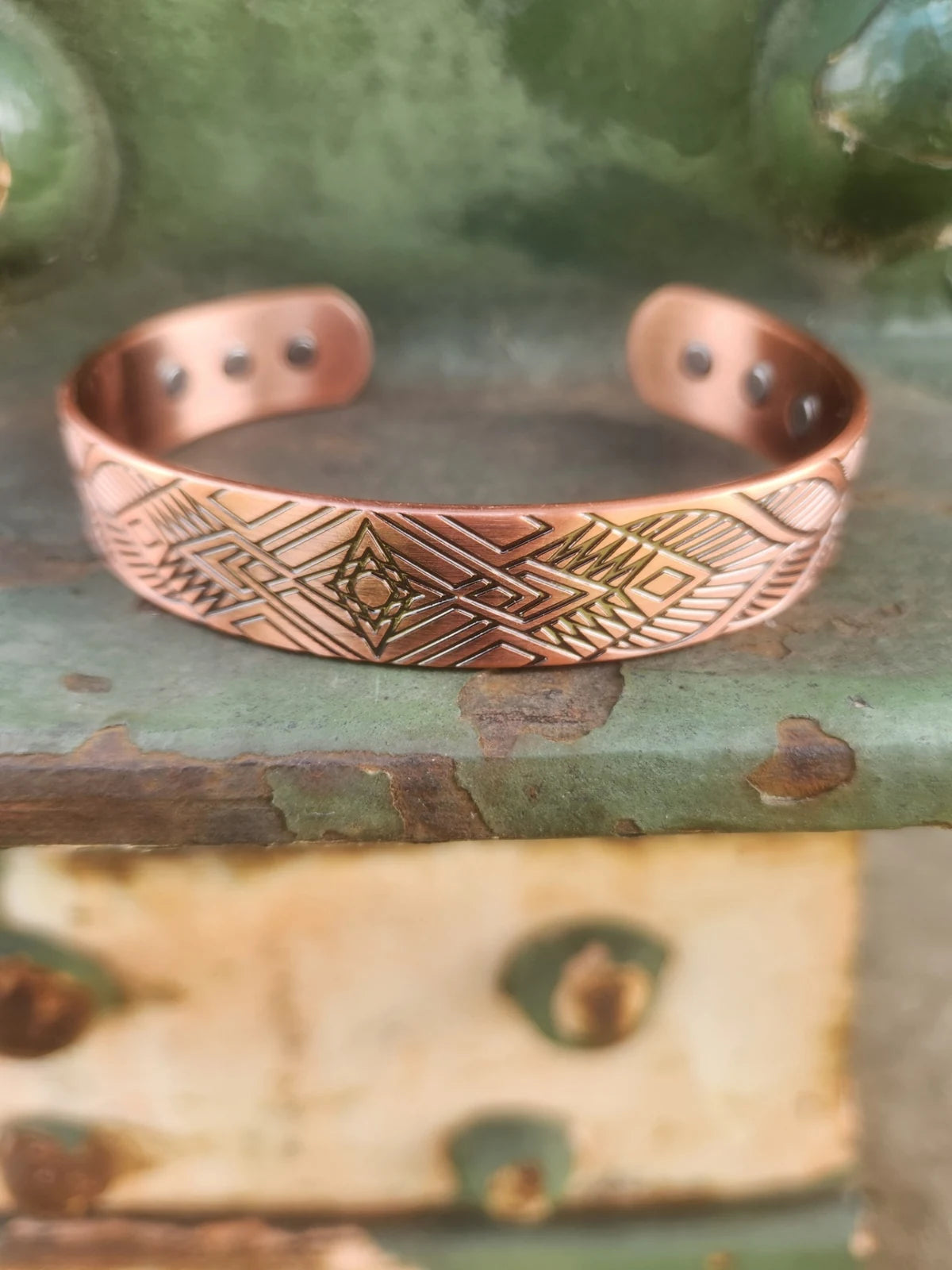 Front view of wide geometric diamond copper cuff with magnetic inserts