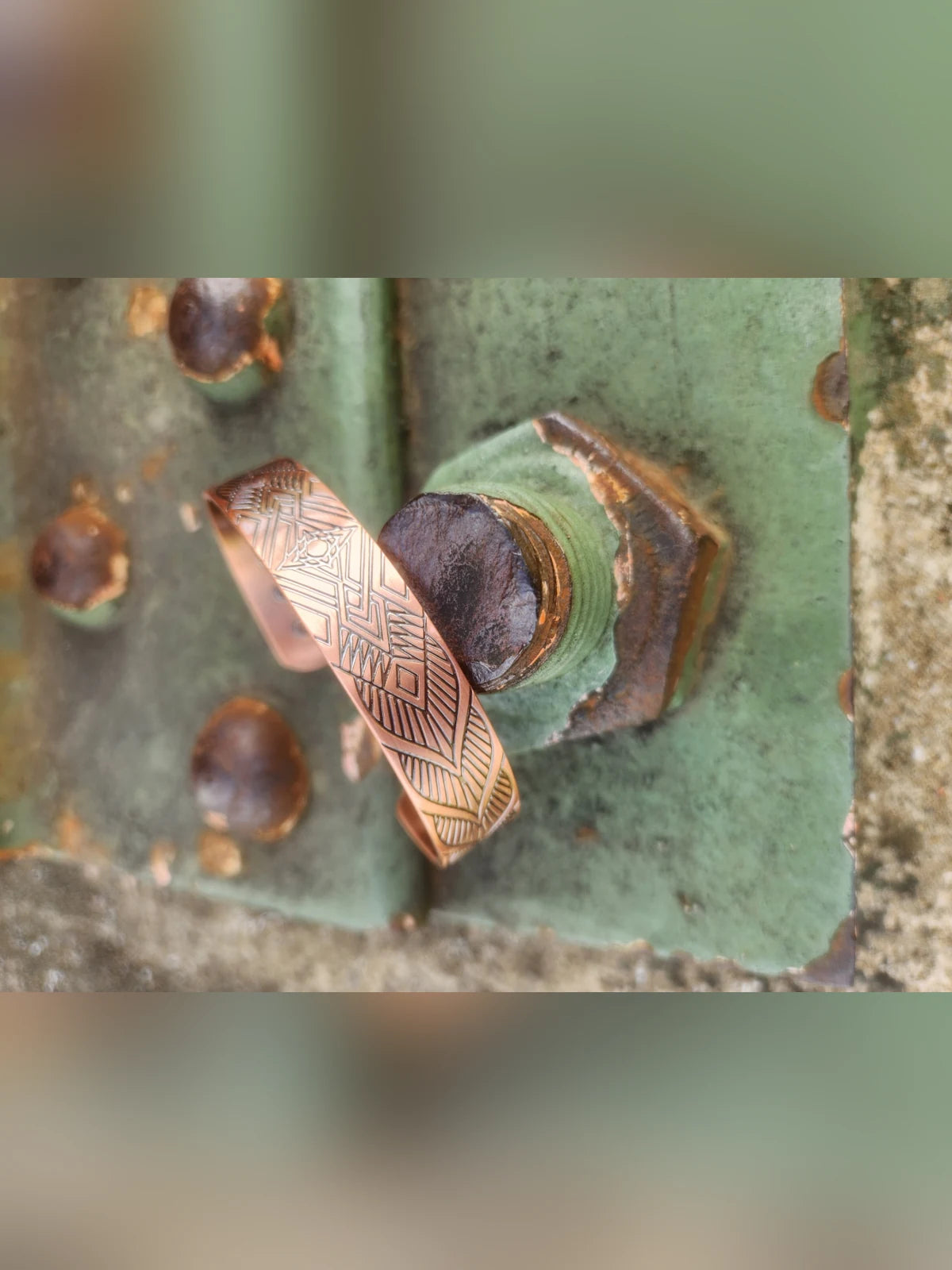 Angled view of wide geometric diamond magnetic copper cuff