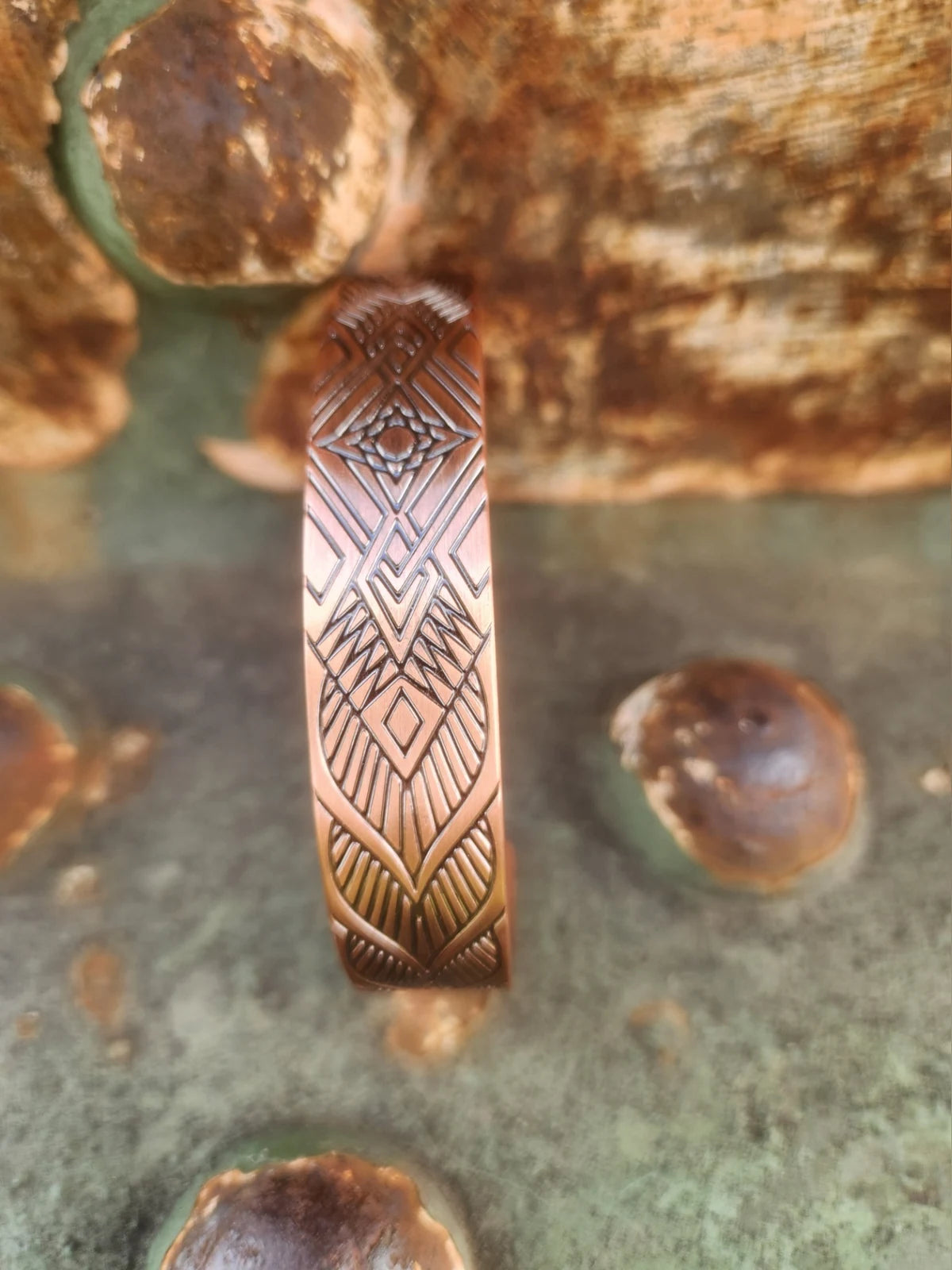 Close-up of geometric diamond pattern on copper cuff