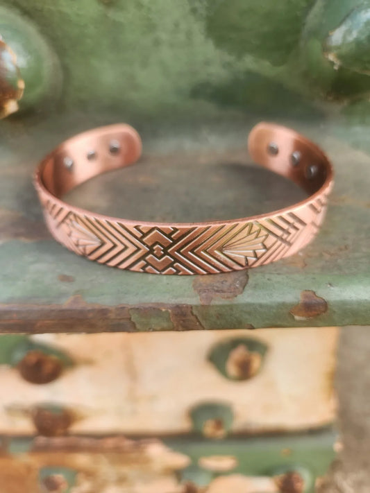 Geometric fan and chevron magnetic copper cuff bracelet shown from the front