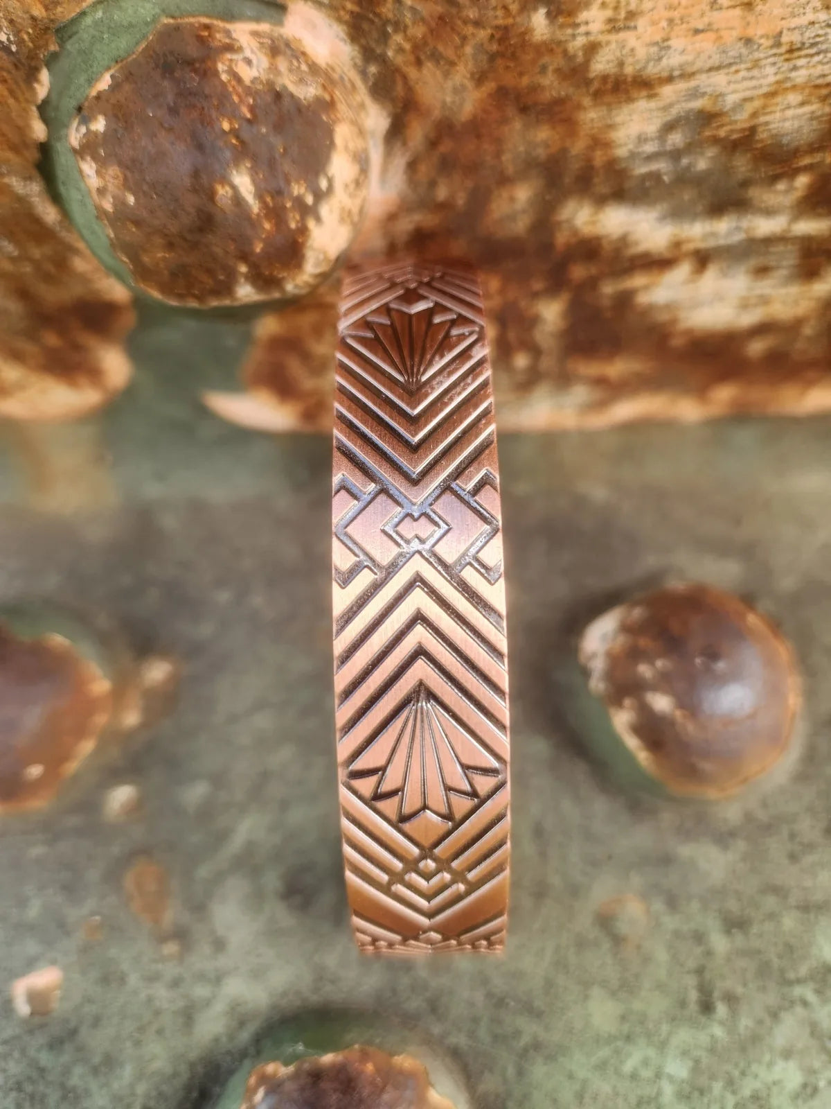 Close-up of geometric fan pattern on pure copper cuff bracelet