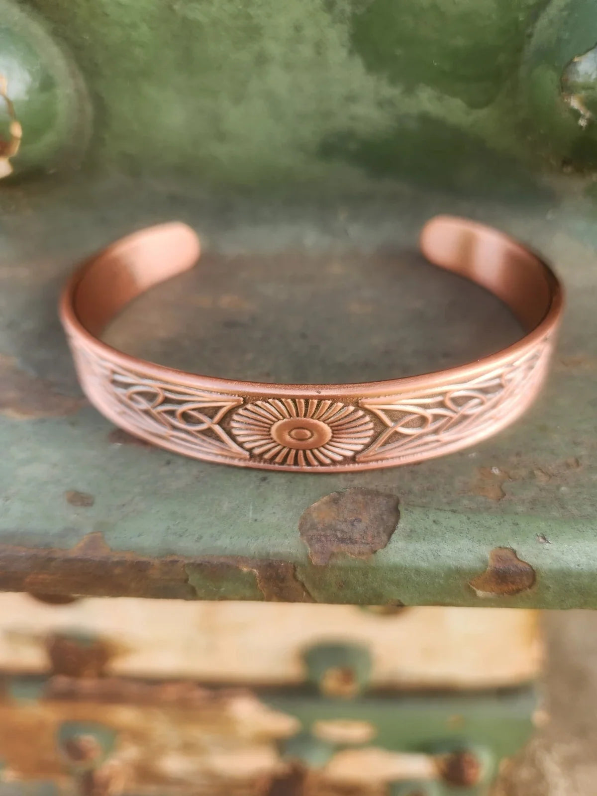 sunburst copper cuff front product photograph in 3:4 portrait format