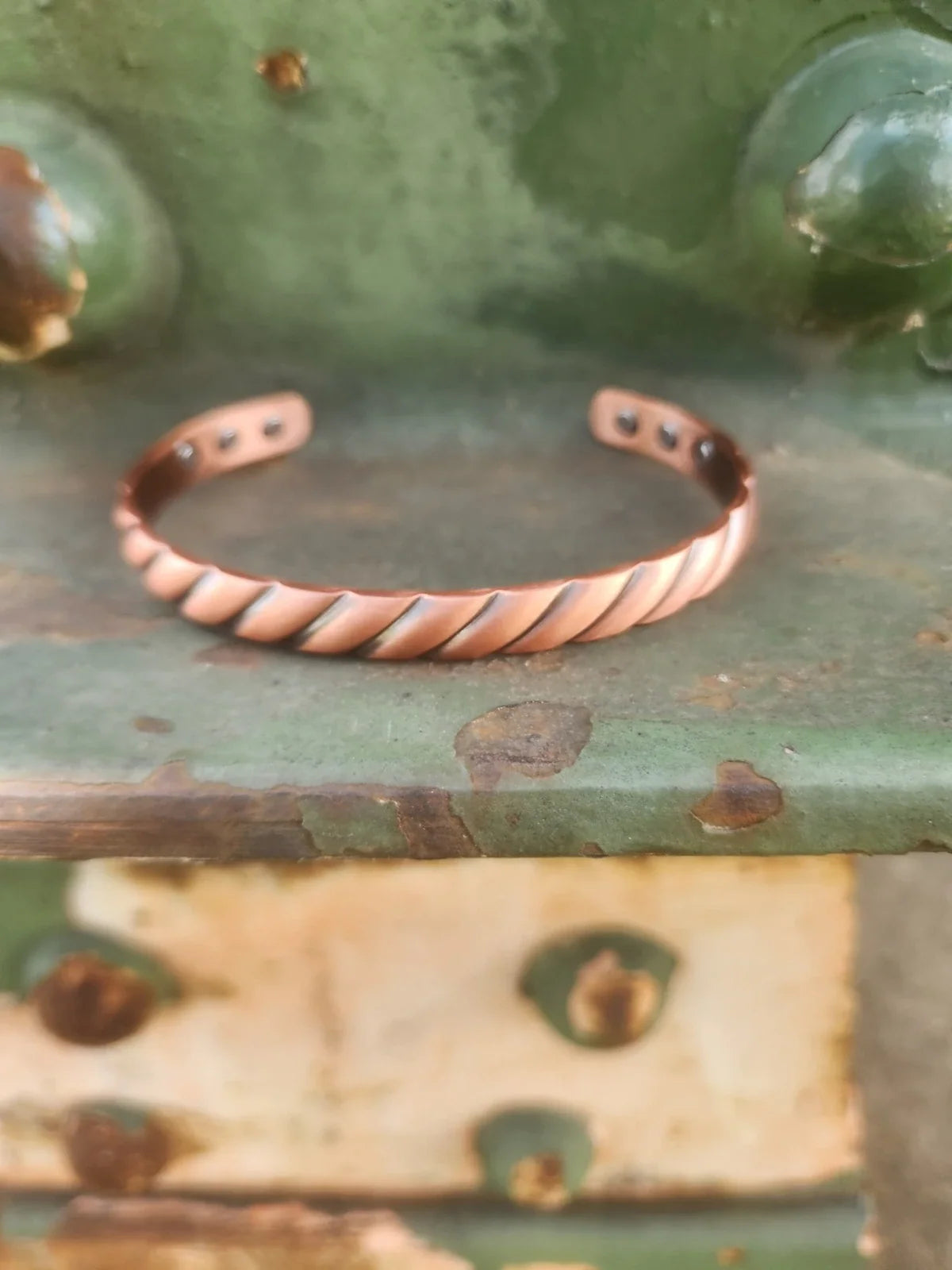 twisted copper cuff front product photograph in 3:4 portrait format
