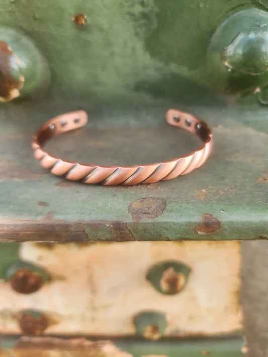 twisted copper cuff front product photograph in 3:4 portrait format